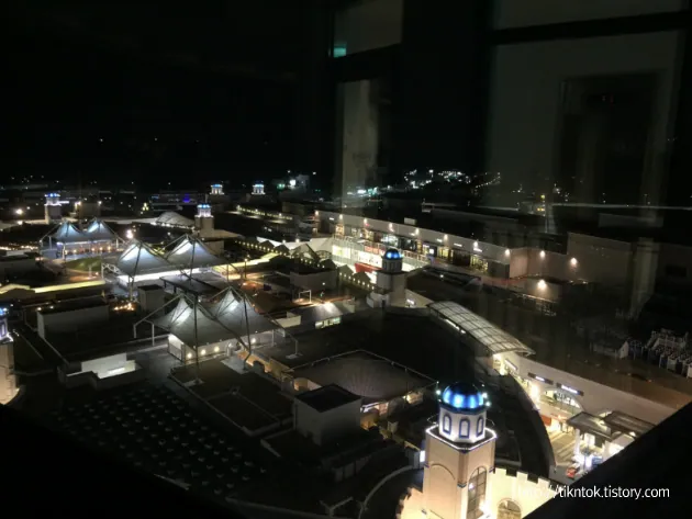 Night view across 롯데몰 동부산점 from its lighthouse-deck area.